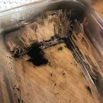 Soot scraped from the glass